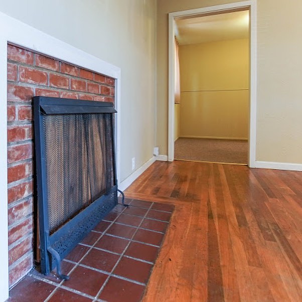 A living room with a functional fireplace | Pierce Real Estate, Hollister, CA 95023